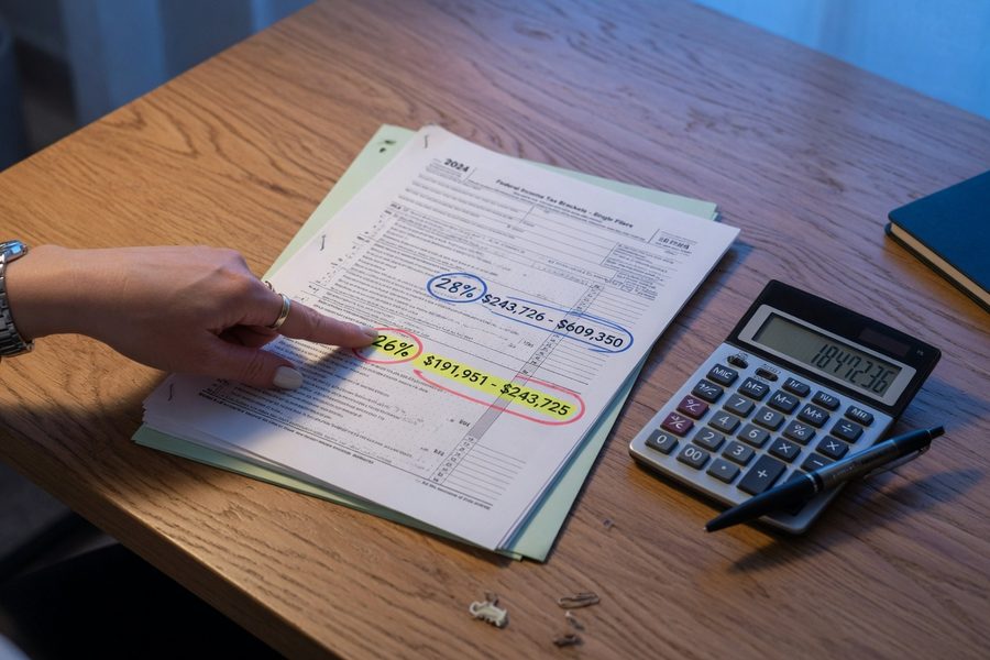 Diagram showing parallel AMT calculation alongside regular tax calculation with key add-back items labeled