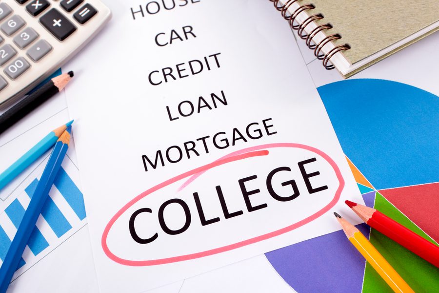 Hands typing a bridge loan application on a laptop with closing documents nearby