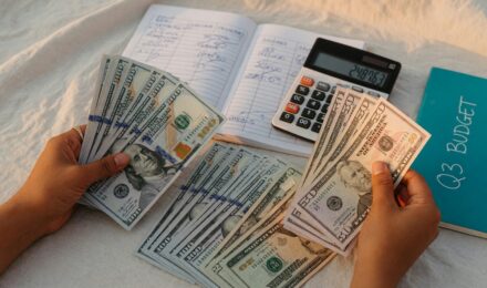Person reviewing budget notes and savings plan at desk