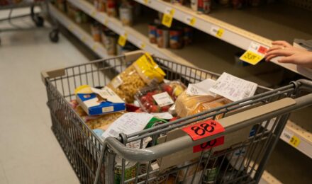 Grocery store shelves with price tags and products at various eye levels
