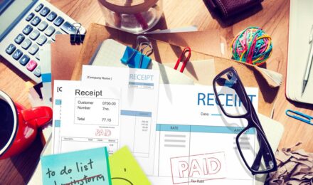 Person reviewing IRS payment plan document with calculator and tax forms on desk