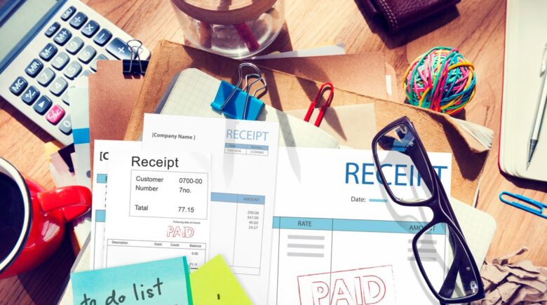 Person reviewing IRS payment plan document with calculator and tax forms on desk