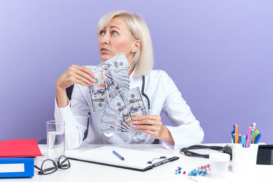 Stack of medical receipts with a calculator and Schedule A form