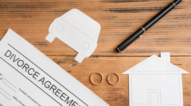 Person reviewing mortgage documents and credit report after divorce settlement