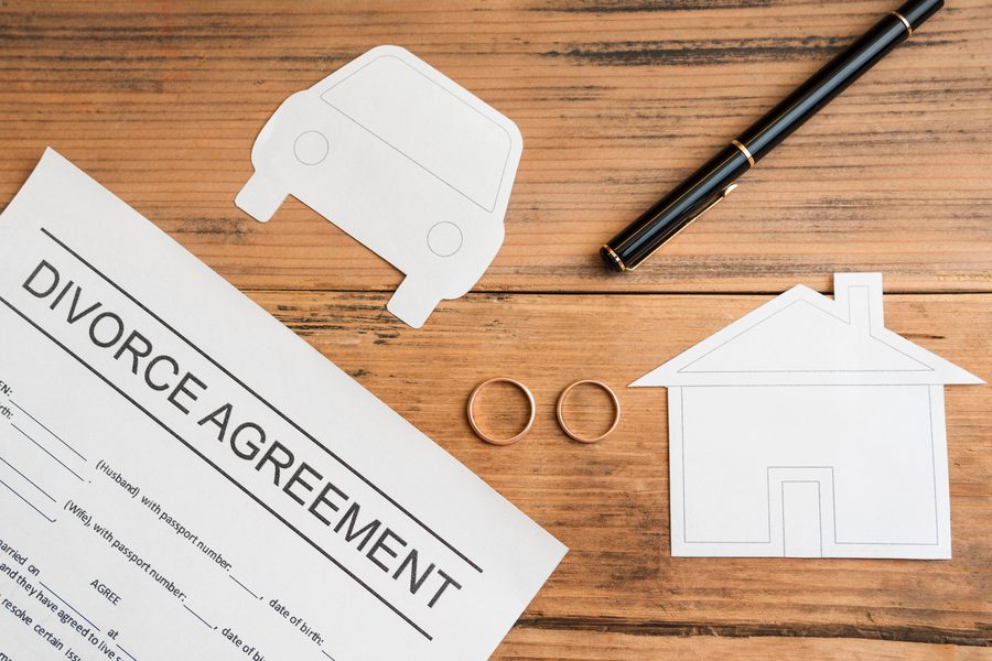 Divorce settlement paperwork next to a mortgage statement