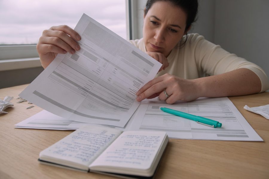 Stack of paid-off credit card statements with a growing credit score graphic