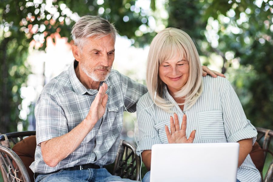 Couple sitting with a financial advisor discussing a retirement budget graph