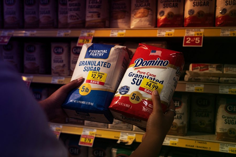 Side-by-side comparison of store brand and name brand pantry staples on grocery shelf