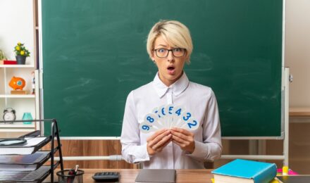 Teacher working at desk with budget spreadsheet and debt payoff timeline