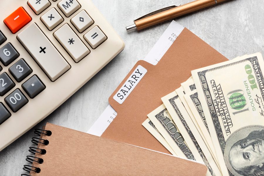 Independent contractor in Dallas reviewing a spreadsheet displaying their home office setup with desk, computer, and labeled expense categories