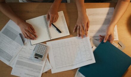 Couple reviewing financial documents and planning together at a desk