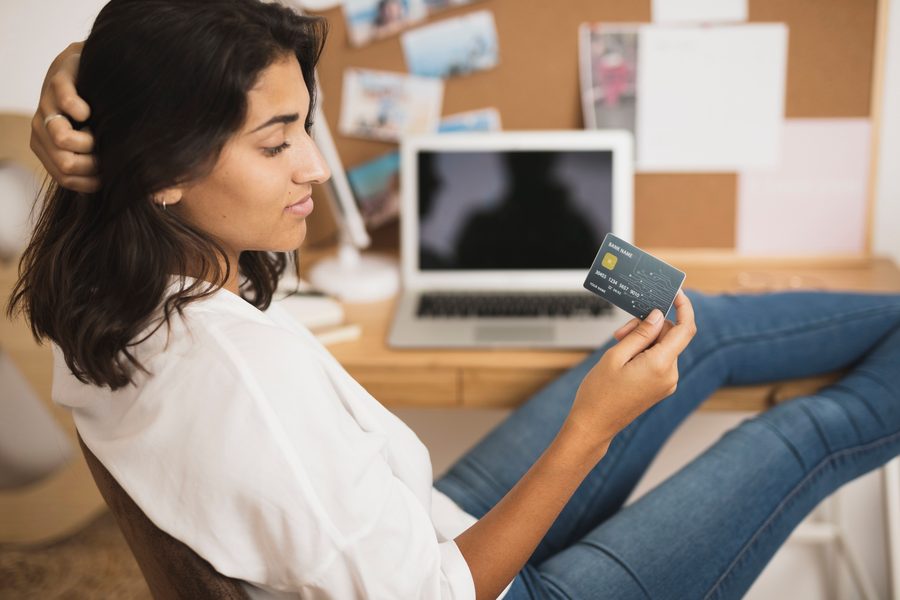 A person reviewing bank statement line items and highlighting recurring subscription charges