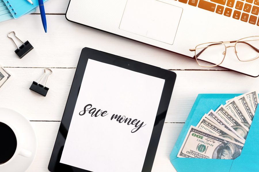 Person reviewing savings rate calculation on paper with calculator and bank statements