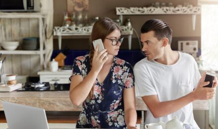Married couple reviewing bank account statements together at home