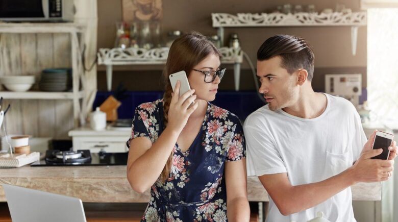 Married couple reviewing bank account statements together at home