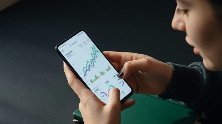 Side-by-side comparison of micro-investing app icons and fee structures on a smartphone screen