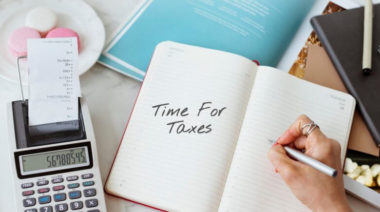 A person reviewing a 1099-NEC form and calculating tax payment