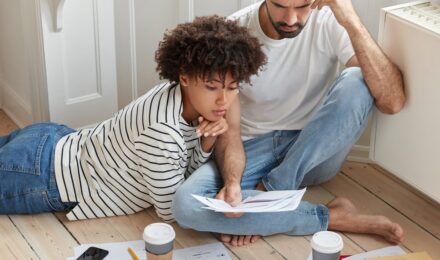 First-time homebuyer reviewing finances and mortgage documents at a desk