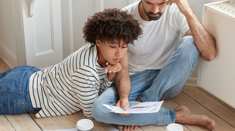 First-time homebuyer reviewing finances and mortgage documents at a desk