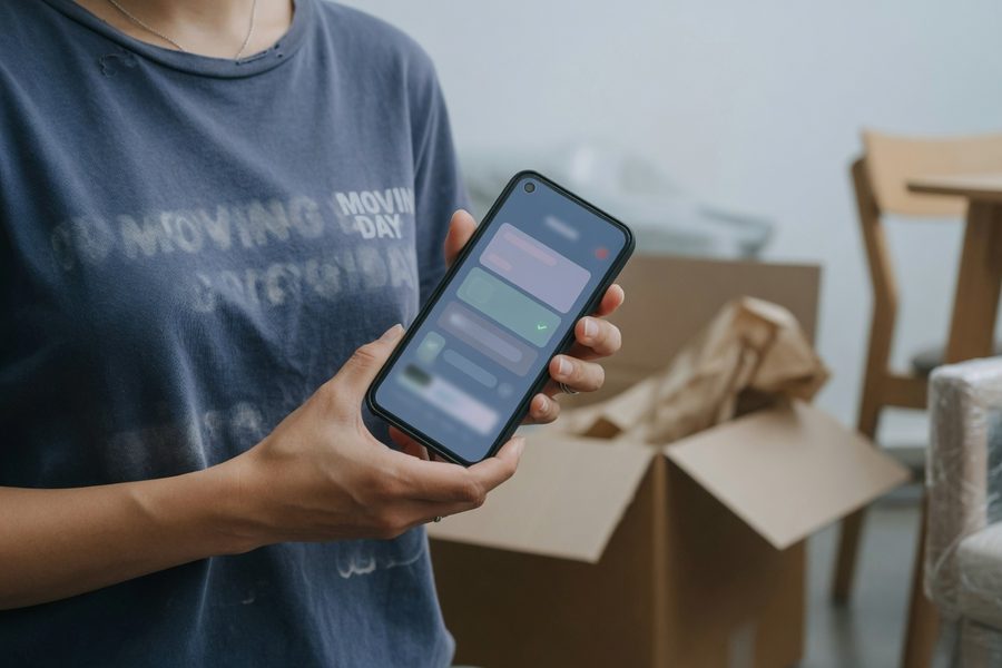 Smartphone with Buy Now Pay Later app warning next to mortgage papers
