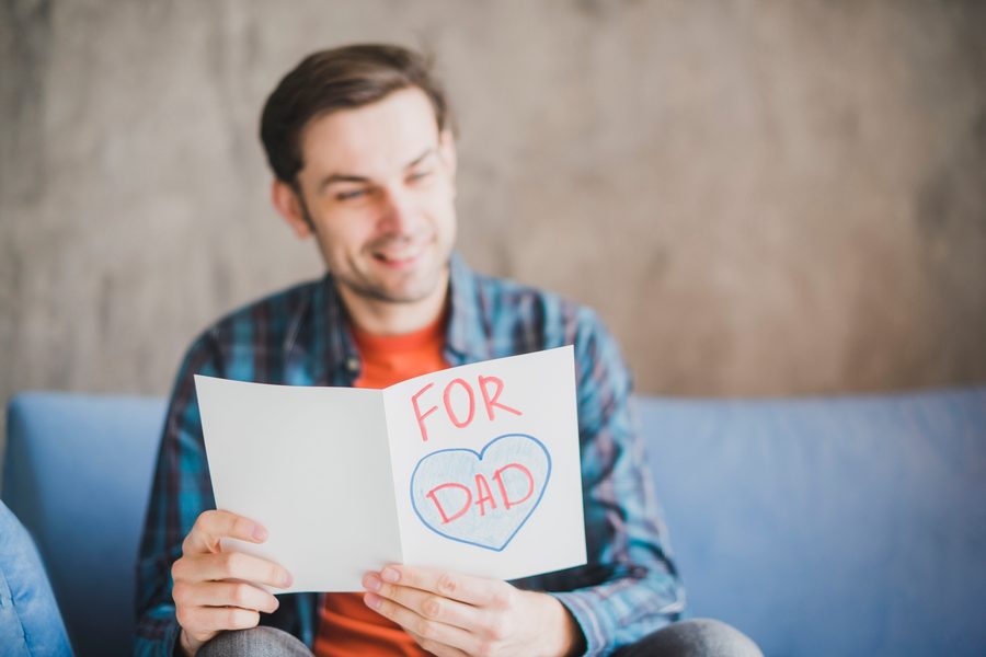 Ohio single father reviewing childcare voucher paperwork at kitchen table